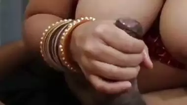 Desi Bhabhi shows boobs and gives a handjob