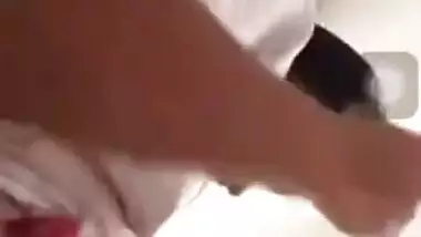 Girl performs XXX show and pulls up white T-shirt to expose boobs