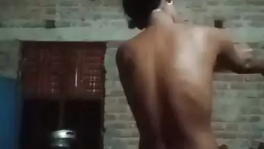 Village girl applying lotion to full nude body